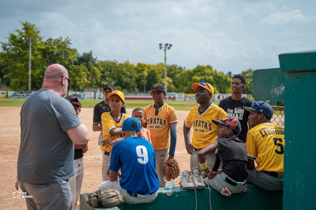 Dominican baseball coach instructing high school players during training camp