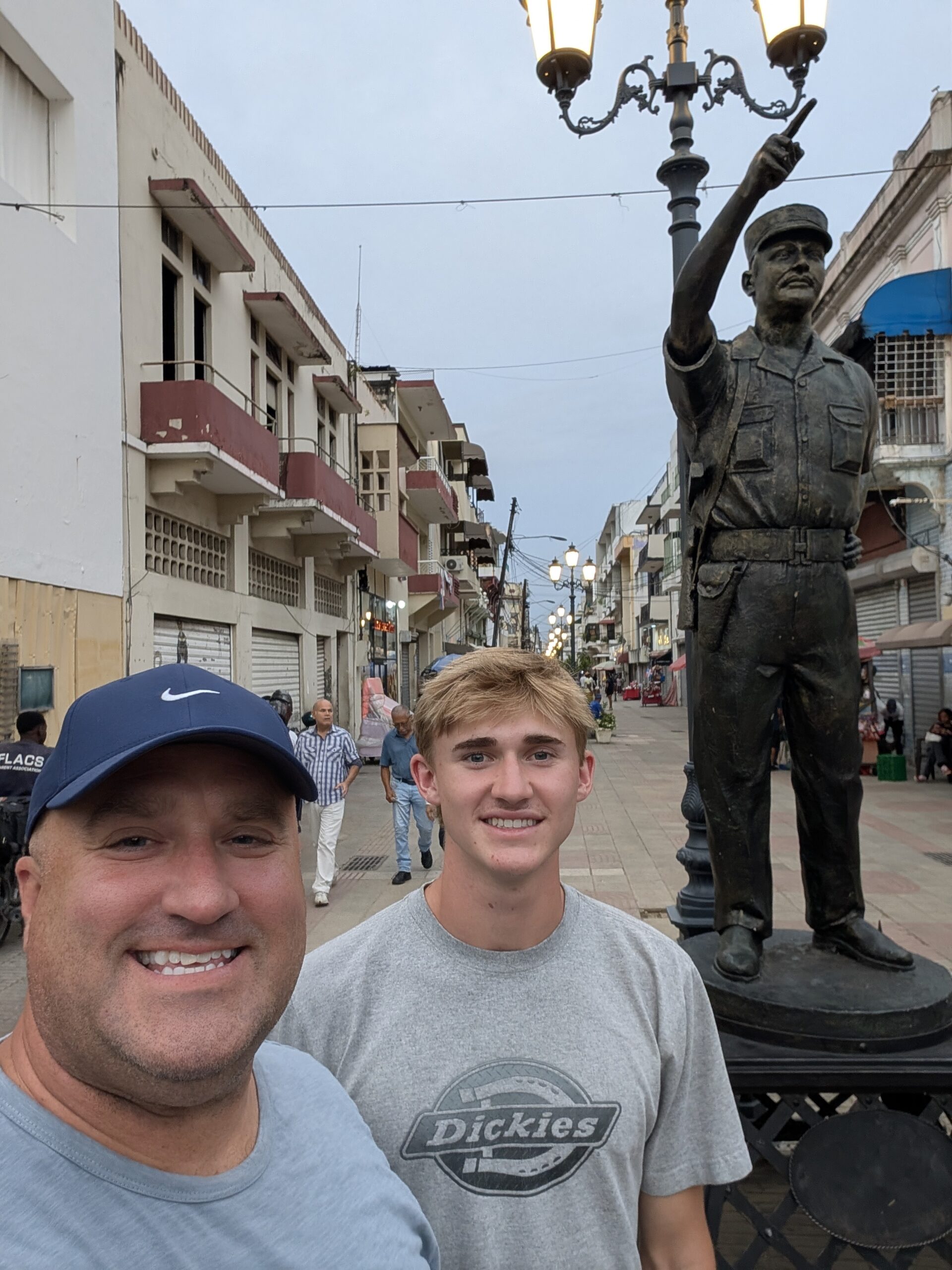 Brandon Byers and his son Austin return to the DR and stand on the Conde street in Santo Domingo